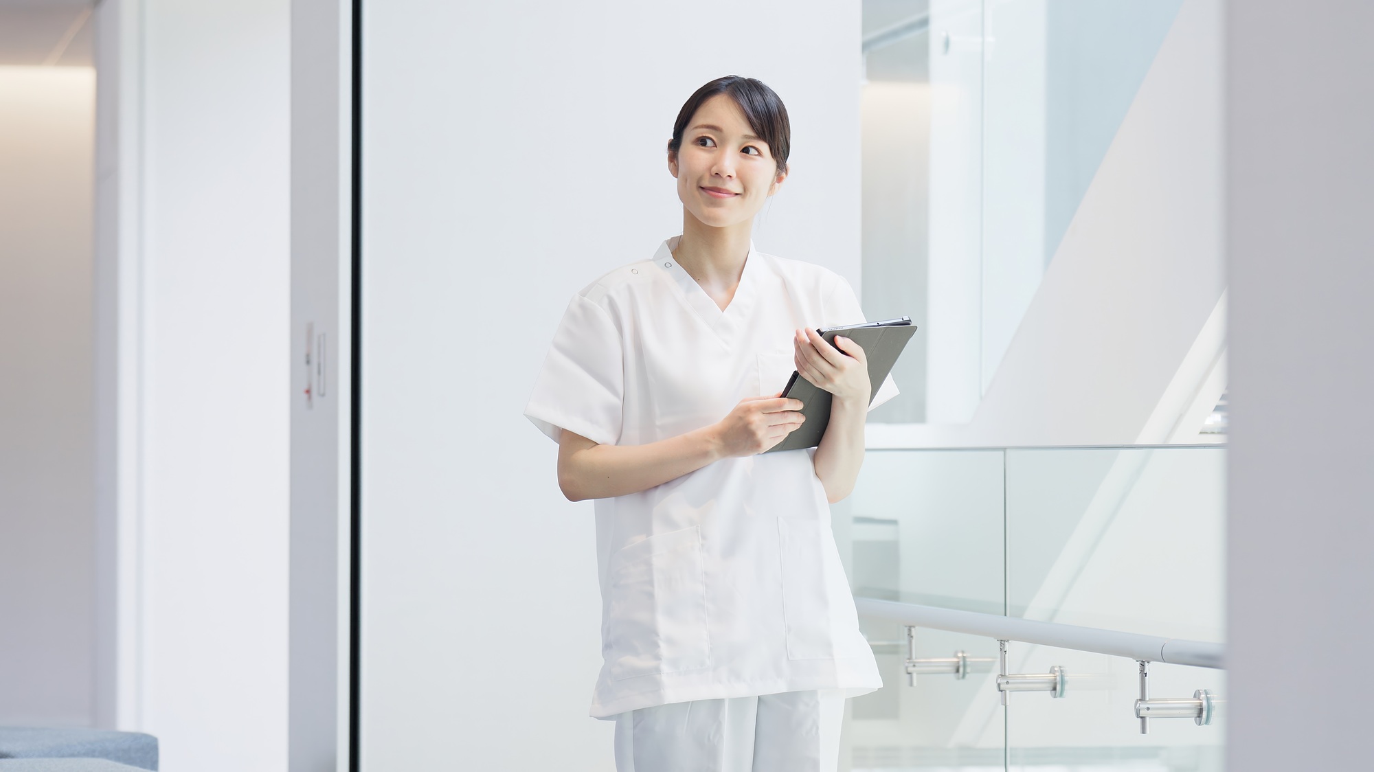 Nurse Practitioners opening a Medical Spa and CreationWebs can help! A nurse operating a tablet with a smile